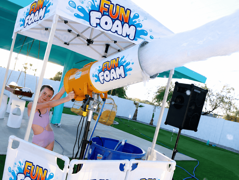 Children playing and dancing in giant foam bubbles during a Fun Foam Party birthday party in Michigan with music, beach balls, and professional entertainment.